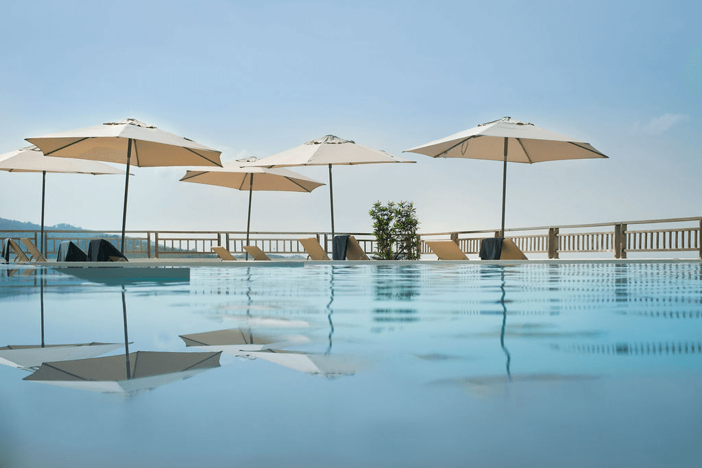 Infinity pool with parasols overlooking the sea at Malee Highlands